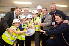 Russell Homes sales manager Gill Richardson with North Heywood councillors Ray Dutton and Peter Rush, who is also chairman of Rochdale Hornets, Russell Homes’ Roger Fitton and Hornets chief executive Steve Kerr, Year 6 pupils Aroni Thomas, 10, Jamie Wilson,  10, Hannah Thompron, 11 and Genipher Payne, 10, and Hornets Foundation coach Kirsty Crehan