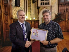 Rochdale in Bloom chairman, Roy Down (right) presents a special award to Tracy Hibbert for all his efforts