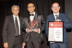 Asad Shamim (centre) is presented with the award by Shadow Secretary of State for Communities and Local Government, Andrew Gwynne MP (right) and Mohammad Pervaiz (left)