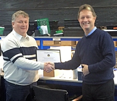 Chris Moore and Mark Tibbenham with his long-service award certificate and gifts