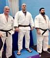 Luke Giller (centre) wins gold and gains his 1st Dan (Black Belt) 