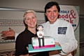 Rochdale Food and Drink Festival<br /> Local artisan cake-maker, Natasha Brown presents Jean-Christophe Novelli with a cake, complete with a sugar-paste portrait of him