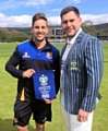 Rochdale Captain Michael Harling, resplendent in his new club blazer hands over the Pennant to Litttleborough skipper Thomas Kaber