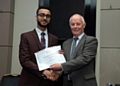 Areeb Haidery receiving a special award for progress presented by Bill Dwyer