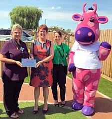 Gail Hooper, director of children's services (2nd from left), presents the Millie's Mark award to nursery staff