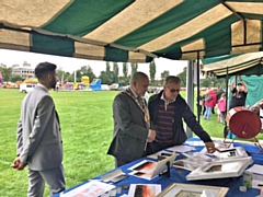 Artist Steve Whitworth shows his artwork to the Mayor of Rochdale, Mohammed Zaman, at MiddFest