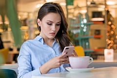 Young woman checking her mobile phone