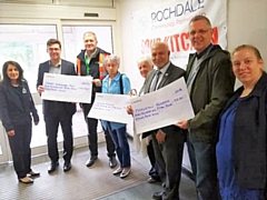 Former councillor Chris Furlong (third from left) presented three cheques to charity raised from his ‘Three Marathons-Three Months-Three Countries’ challenge earlier this year