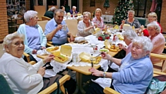 Residents of Derek Walker Court enjoying their free fish and chips