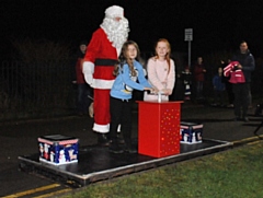 Holly Atkin and Liberty Shepherd turning on the Christmas lights in Whitworth with Father Christmas