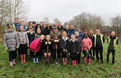 Volunteers, including Mayor of Rochdale Billy Sheerin, pause to celebrate their hard work in planting 375 tree saplings