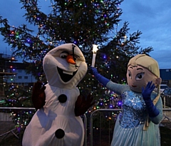 Elsa and Olaf from Frozen used their magic to light up the tree outside the community hub