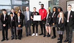 Axel Tuanzebe with staff and students from St Cuthbert's RC High School