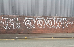 Graffiti ‘artists’ struck overnight, spraying an illegible tag on the wall outside Storage World Middleton