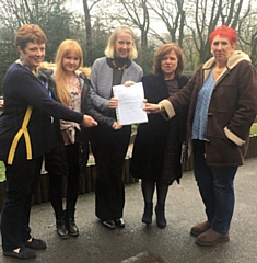 Liz McInnes MP receiving the petition from Headteacher Janet Cook, Cllr Donna Martin, and parents