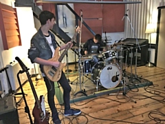 Oliver Norris on guitar and Ryan Pye on drums in the recording studio