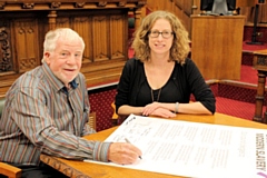 Councillor Allen Brett, leader of Rochdale Borough Council, signs the Charter Against Modern Slavery; with Claire McCarthy, General Secretary of the Co-operative Party