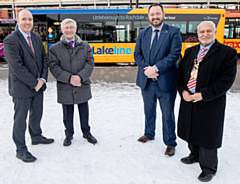 Mayor Mohammed Zaman and MP Tony Lloyd with Transdev CEO Alex Hornby in front of a new Lakeline bus