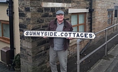 Bill Williams with the sign, before it was returned to its rightful place