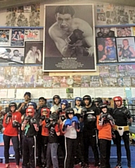 Hamer youngsters under a giant-sized picture of their hero, Jock McAvoy
