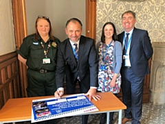 Amanda Ferguson, Blue Light Champion Co-ordinator; Peter White, Chairman; Laura Smoult, HR Project Manager and Michael Forrest, Interim Chief Executive sign the Blue Light Pledge to take action to reduce mental health discrimination