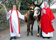 Vicar of St Andrew's, Dearnley, the Rev Rachel Battershell (left) and Cherry Vann, Archdeacon of Rochdale outside church with donkeys Tyson and Blossom before the Palm Sunday service
