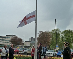 The Saint George cross being raised