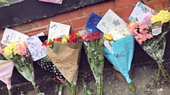 Tributes to Saima Riaz outside a property on Royal Street