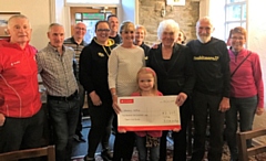 Ella Chadwick presents a cheque to Springhill Hospice