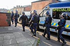 Team of police officers executing warrants at properties across Heywood and Bury