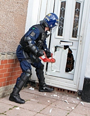 A team of police officers executed warrants in early morning raids (stock image)