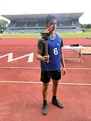 Matthew Hankinson holding the 1942 and 2012 Olympic torch