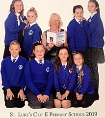 Yvonne Weatherhead, MBE with Isabelle Radcliffe, Remi Sedgley, Phoebe Drennan, Genipher Payne, Evie Chubsey, Grace Lemon-Thompson, Niall Middleton and Aroni Thomas from St Luke’s Primary School, Heywood