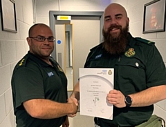 Paramedic, Jaroslaw Wierzycki is presented with a certificate and NWAS baby pin badge