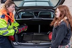 Highways England traffic officer Kelly Rudge checks engine oil with student Shelby Thomas