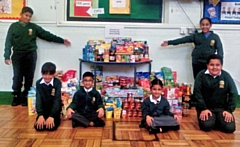 Children from Brimrod Primary School with their harvest donations for Rochdale Foodbank