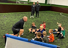 Stephen Dawson (foreground), Richard Tracz (back left) and Kelvin Etuhu (back right) have been coaching children locally at the R-Kikx Academy