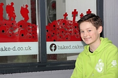 Charlie Hastewell with the poppy window he created at Bacup’s Baked Cakes