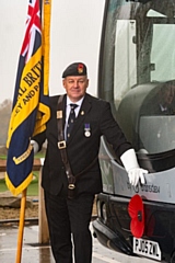 Royal British Legion Standard Bearer Richard Fletcher with one of the buses displaying its own poppy as local bus firm Rosso remembers the fallen