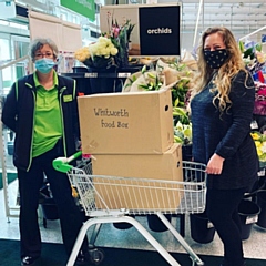 Naomi Kenyon (right), Healthwatch Rochdale Involvement Officer, receiving food box donations from ASDA