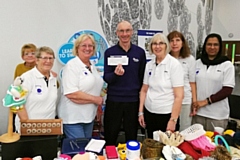 Eamonn Greene from the Stroke Association with a cheque presented by the Knitting Nans