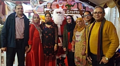 From left: Arshad Mehmood, Erum Mehmood, Attiya Malik, Andrew Johnson (Santa), Saima Kausar, Razia, Shabana Kauser, Azhar Shah