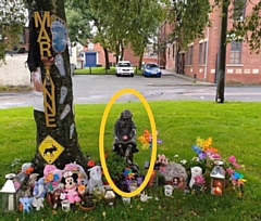 This figure of a girl reading a book has gone missing from Marianne Haboc's memorial site on Taylor Street