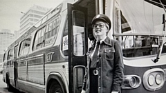 Kathleen Andrews in front of bus