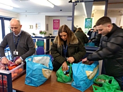 Council officers helping at Rochdale Foodbank, serving a client