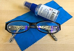 Glasses with cleaning solution and a cloth