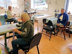 Staff at Mike Goldrick Blinds sewing scrubs for staff at local hospitals