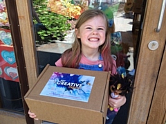 A pupil from St Margaret's CE Primary School in Heywood with her box