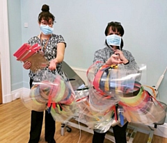 Julie Dowling, Practice Manager at Peterloo Medical Centre takes delivery of the PPE from a staff member at the Middleton Technology School