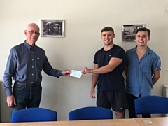 David Canavan (RSPCA trustee) receives the cheque from Brad and Liam Gartland 